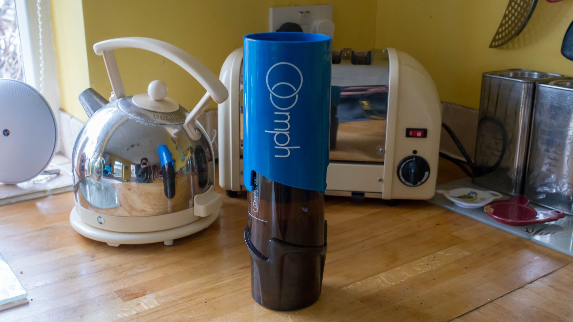 Oomph Coffee Maker on kitchen counter next to kettle.
