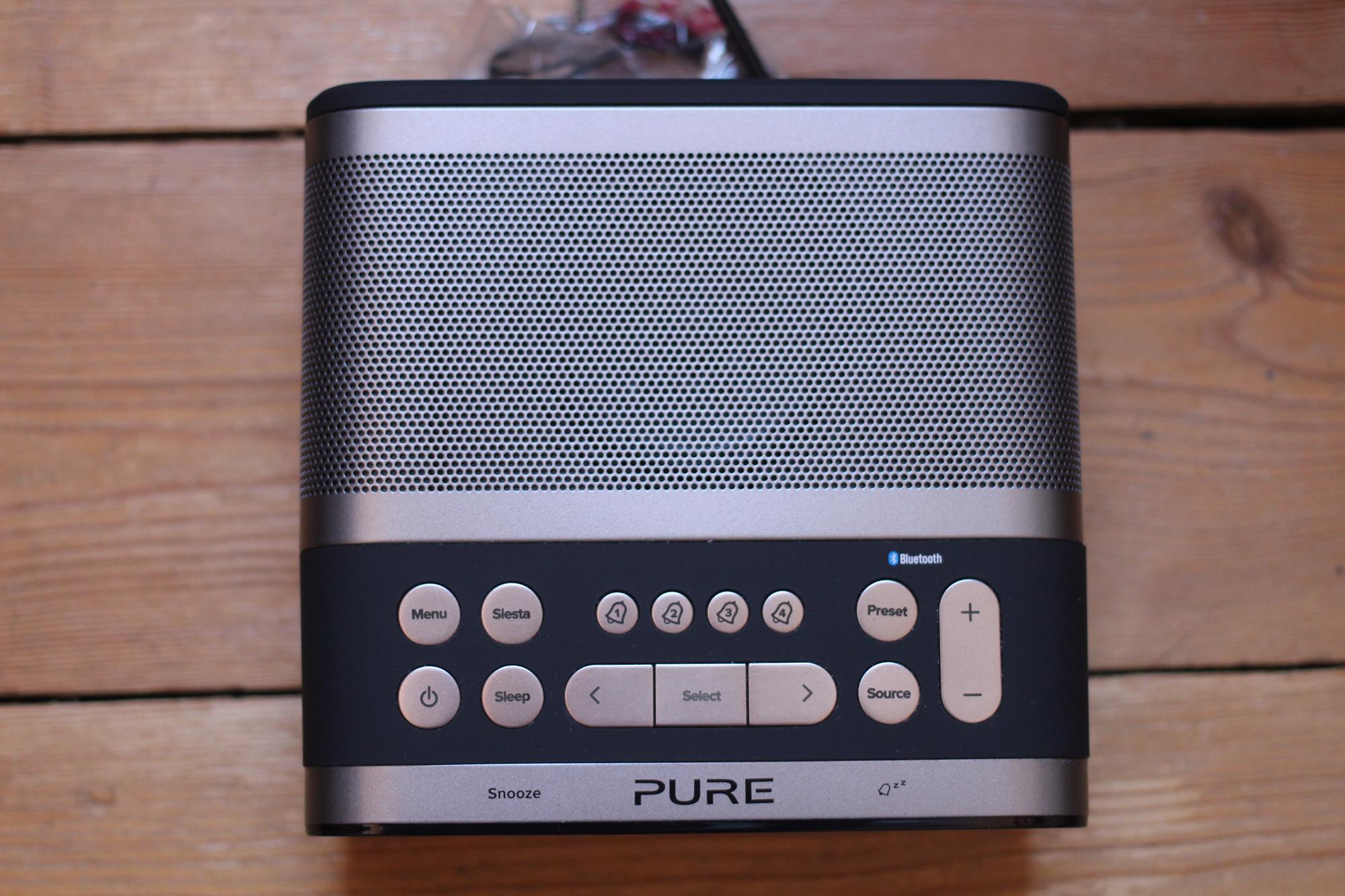 Pure Siesta S6 digital alarm clock radio on wooden table.