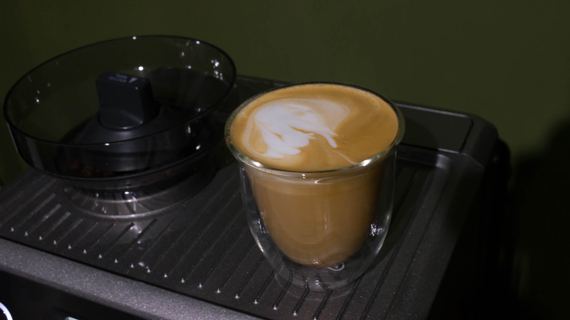 Coffee cup with latte art on Sage Barista Touch espresso machine.