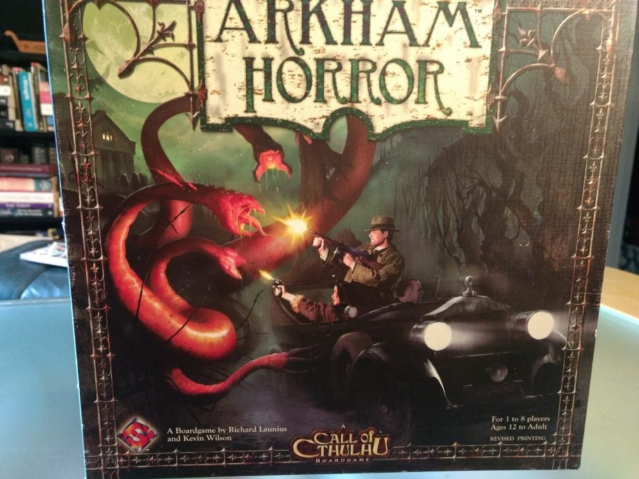 Arkham Horror board game box with artwork and details.