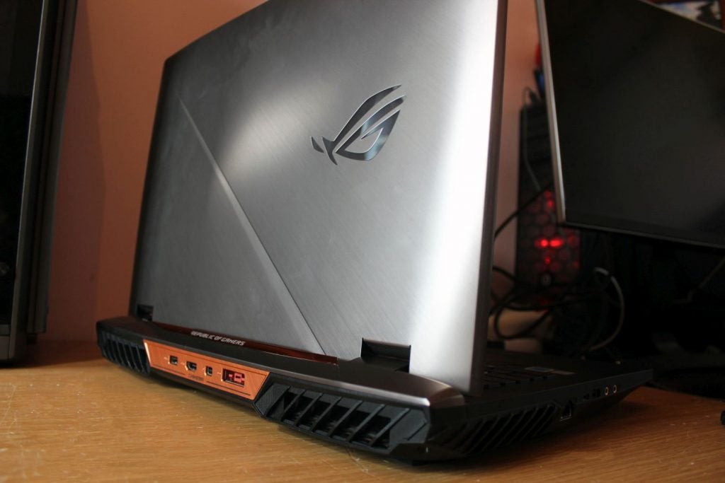 Asus ROG G703 gaming laptop on a wooden desk
