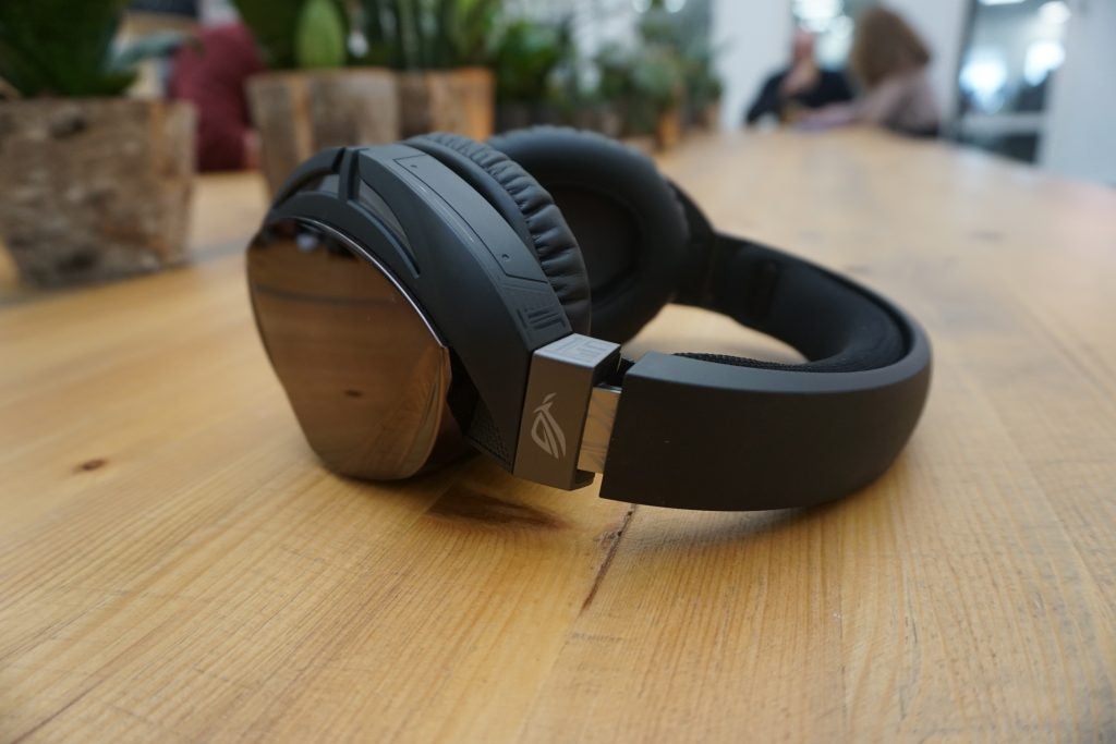 Asus ROG Strix Fusion 500 gaming headset on wooden table.