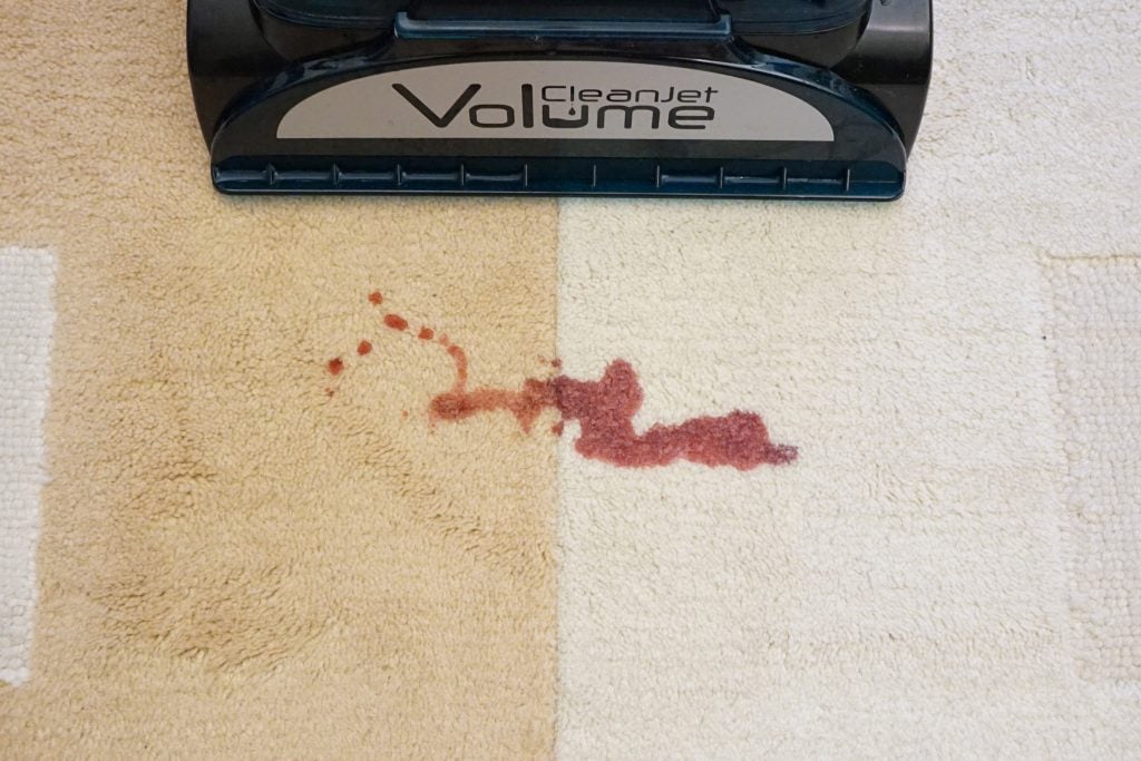 Hoover CleanJet Volume CJ930T facing carpet stain before cleaning.