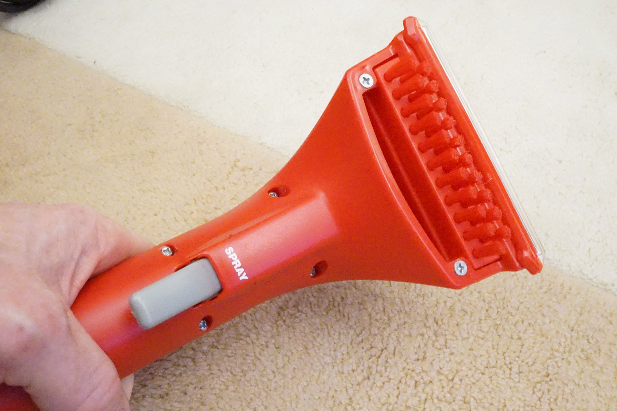 Rug Doctor carpet cleaner handheld brush attachment in use.