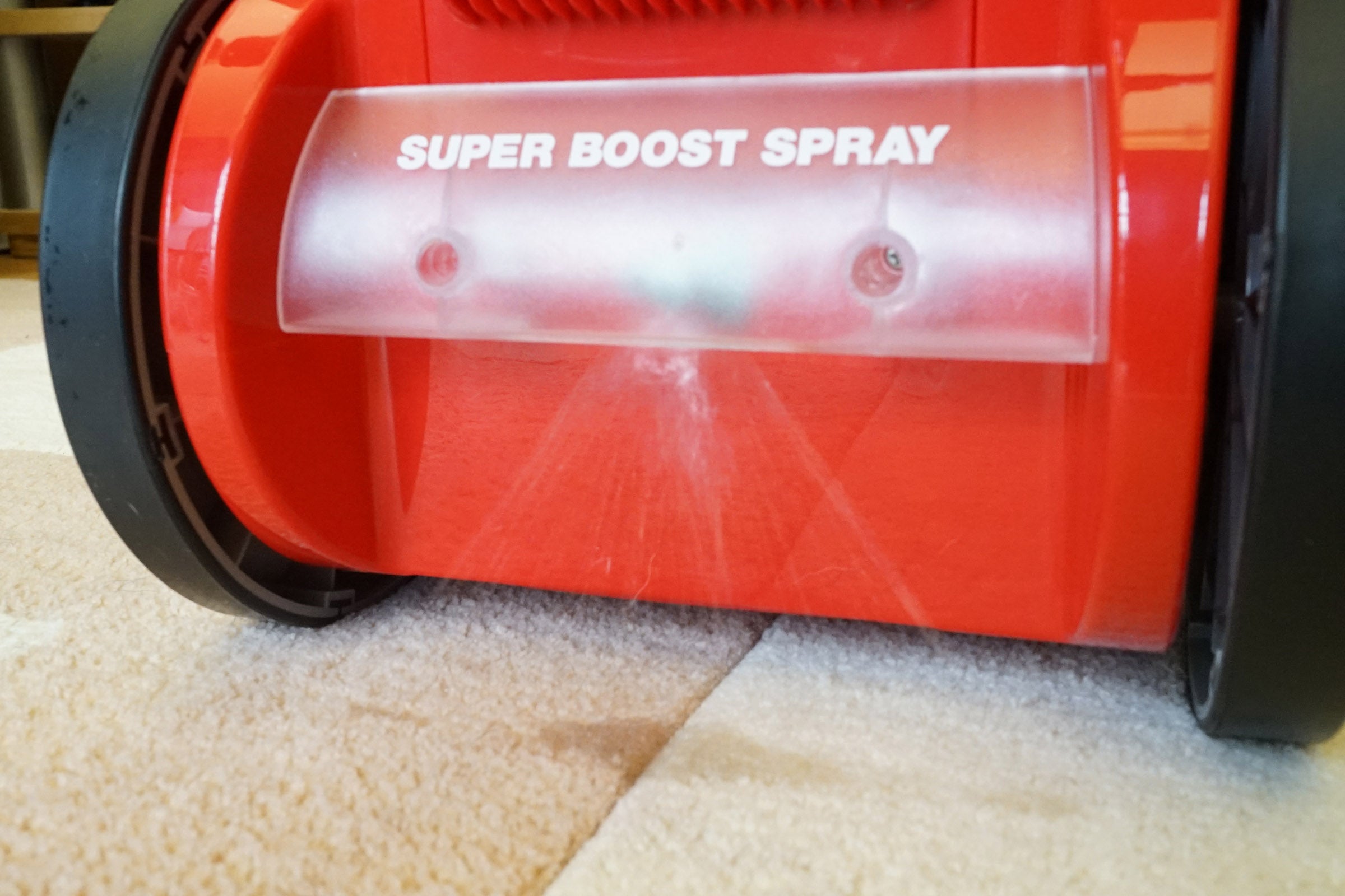 Rug Doctor carpet cleaner using super boost spray on carpet.
