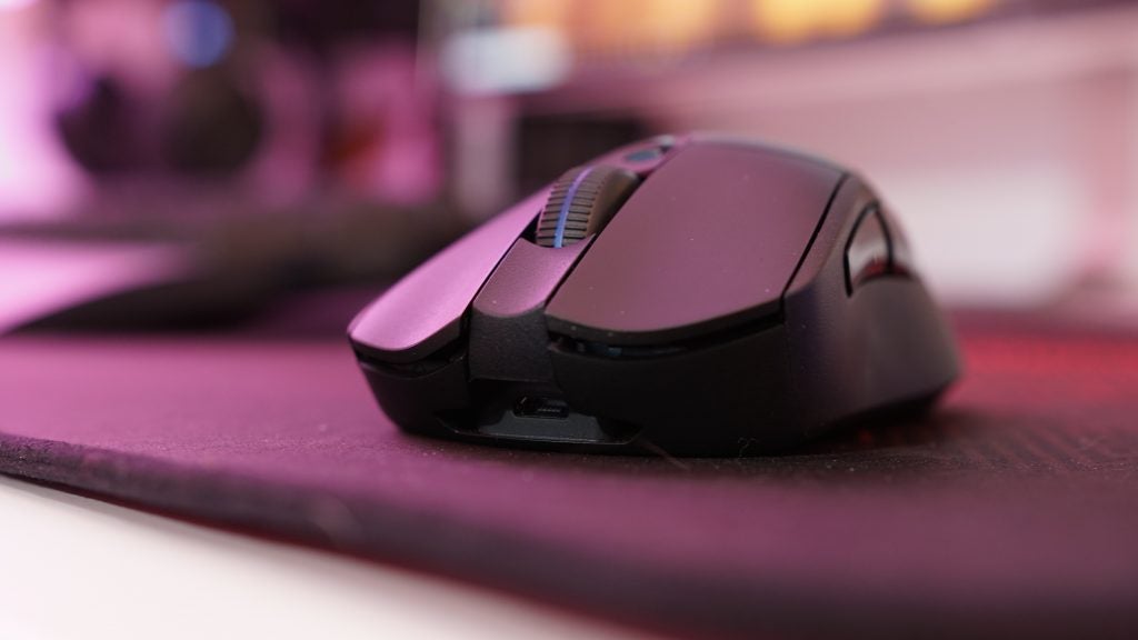 Close-up of a Logitech G703 wireless gaming mouse on a desk.
