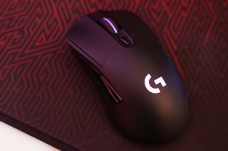 Logitech G703 wireless gaming mouse on patterned surface.