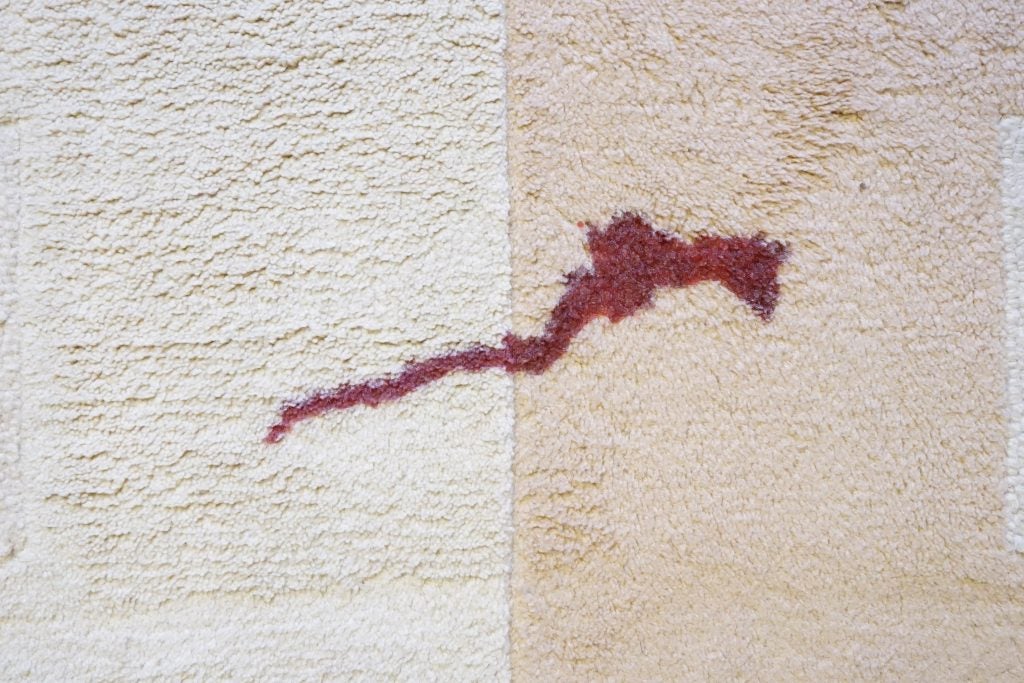 Before and after cleaning wine stain on carpet.