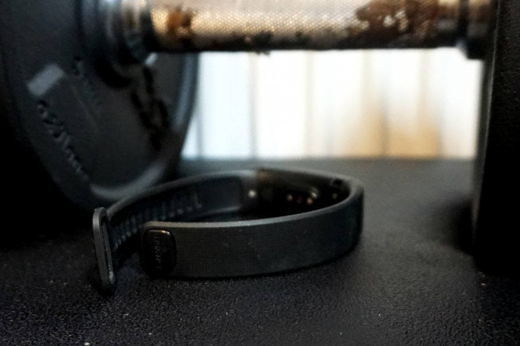 Huawei Band 2 Pro fitness tracker on a black surface.
