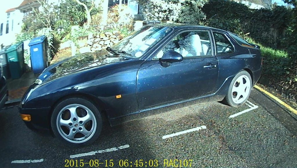 Footage from RAC 107 Dash Cam showing a parked car.Dashboard camera view of parked car with timestamp and model overlay
