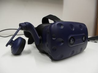 Vive Pro VR headset and controllers on a desk.