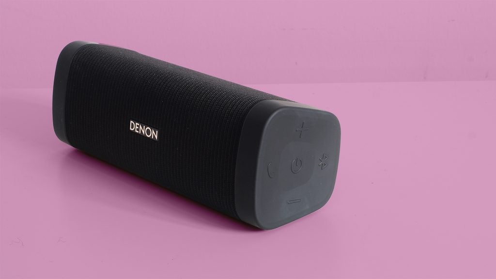 Denon Envaya portable Bluetooth speaker on pink background.