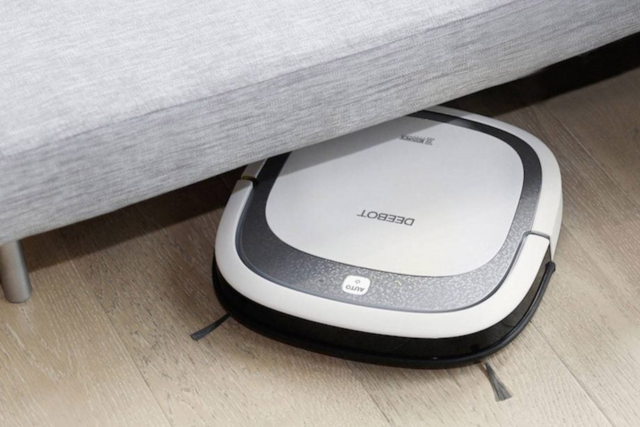 Ecovacs Deebot Slim2 vacuum cleaning under a couch.