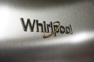 Close-up of Whirlpool logo on stainless steel appliance.