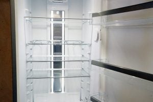 Interior view of empty Whirlpool SW8 AM2C XARL fridge with shelves.