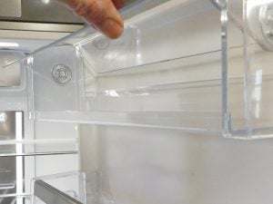 Close-up of Whirlpool refrigerator interior and clear shelves.