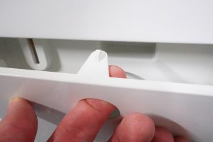 Close-up of Miele WDB020 washing machine detergent drawer operation