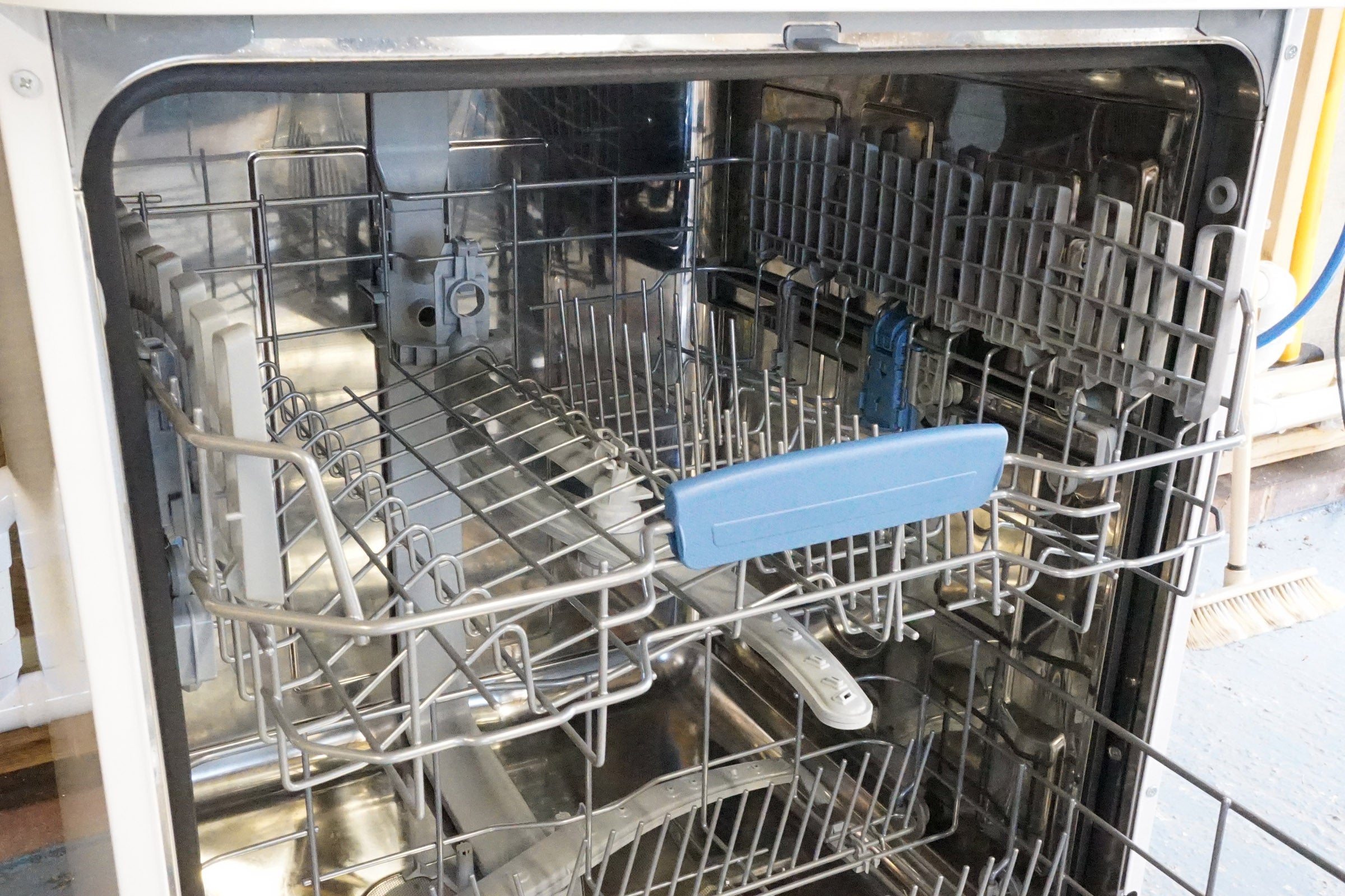 Interior view of an open Indesit dishwasher