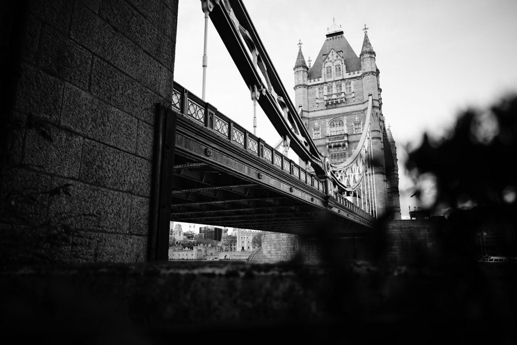 Black and white photo of Tower Bridge with shallow depth of field.