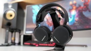 SteelSeries Arctis 3 Bluetooth headphones on desk with PC setup.
