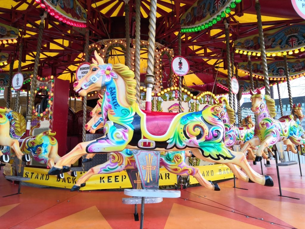 Colorful carousel horses on a merry-go-round.