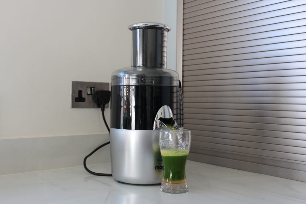 Magimix Le Duo Plus XL juicer with freshly made juice.