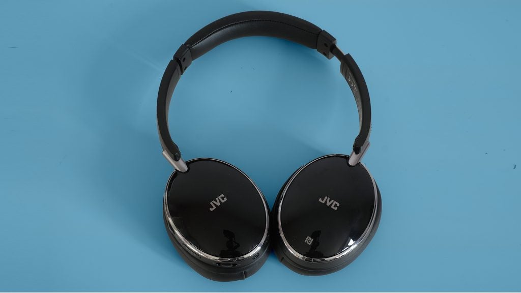 JVC HA-S90BN noise-cancelling headphones on blue background.