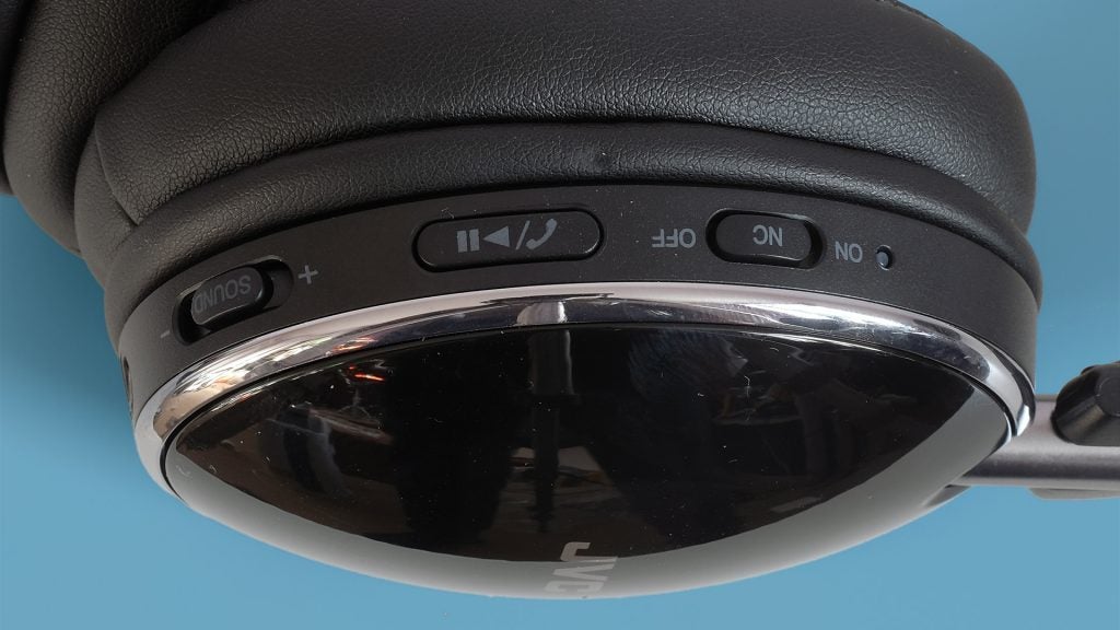 Close-up of JVC HA-S90BN headphones controls and ear cushion.