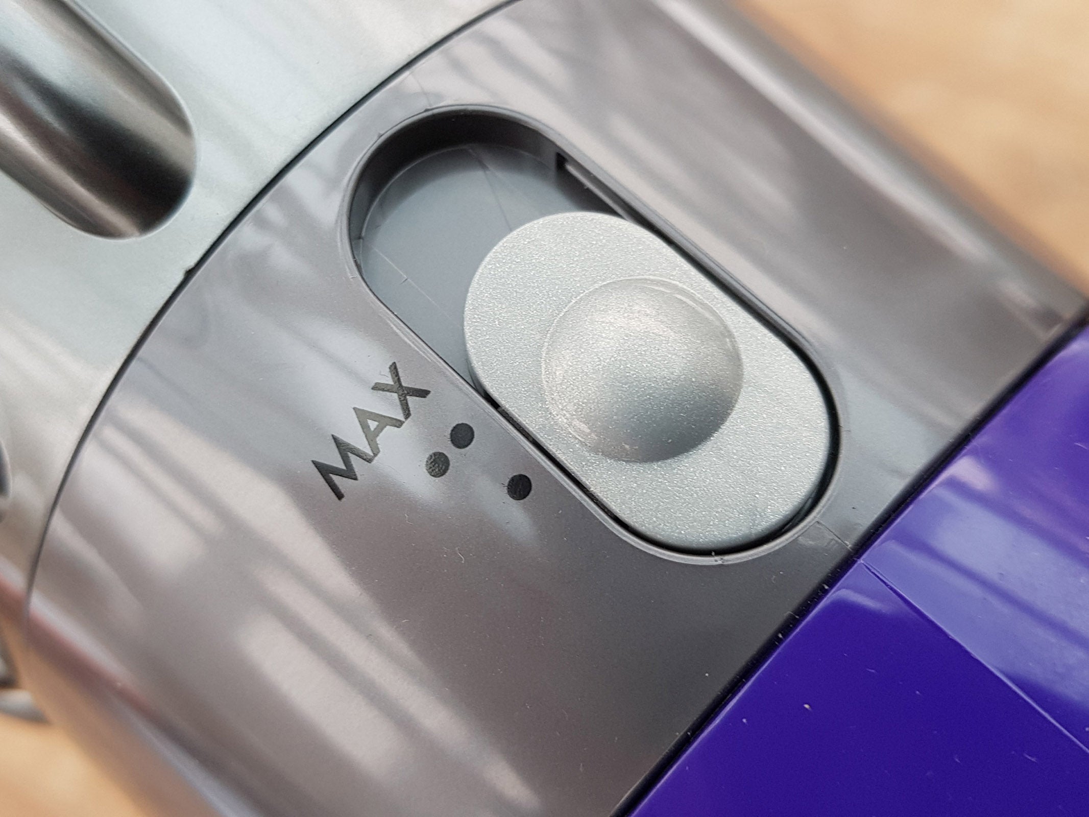 Close-up of Dyson V10 vacuum cleaner's Max power button.