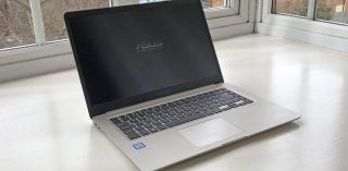 Asus VivoBook S510U laptop on a white windowsill.