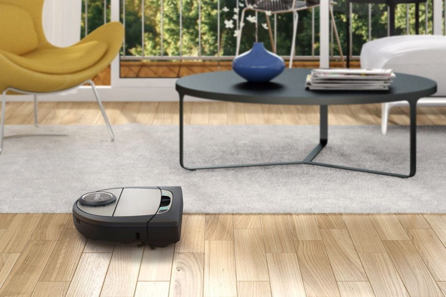 Neato Botvac D7 Connected robotic vacuum cleaning a living room.