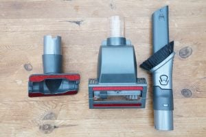 Shark DuoClean vacuum and accessories on wooden floor.