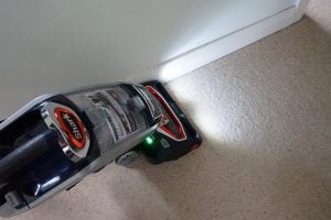 Shark DuoClean vacuum cleaner in use on carpet.