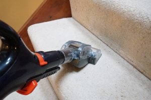 Shark DuoClean vacuum cleaning carpeted stairs.
