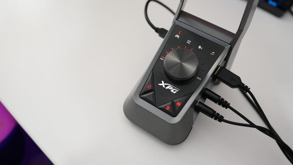 XPG Emix H30 headset amplifier with connected cables.