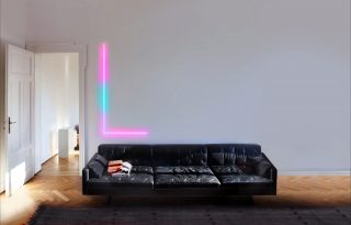 LIFX Beam lights on wall above a black sofa in room.
