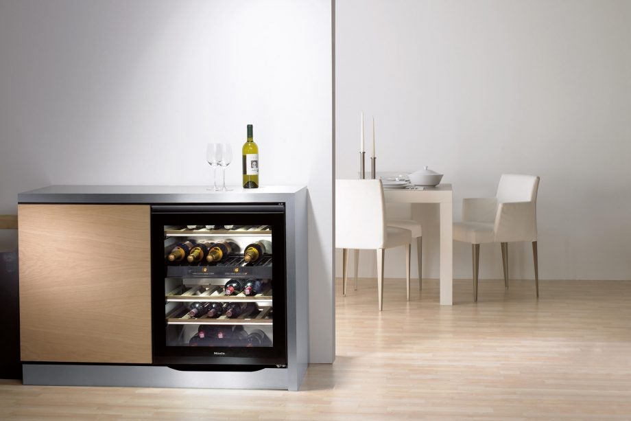 Miele built-under wine conditioning unit in modern kitchen.