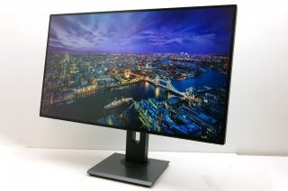 Acer ProDesigner PE320QK monitor displaying a vibrant cityscape image.
