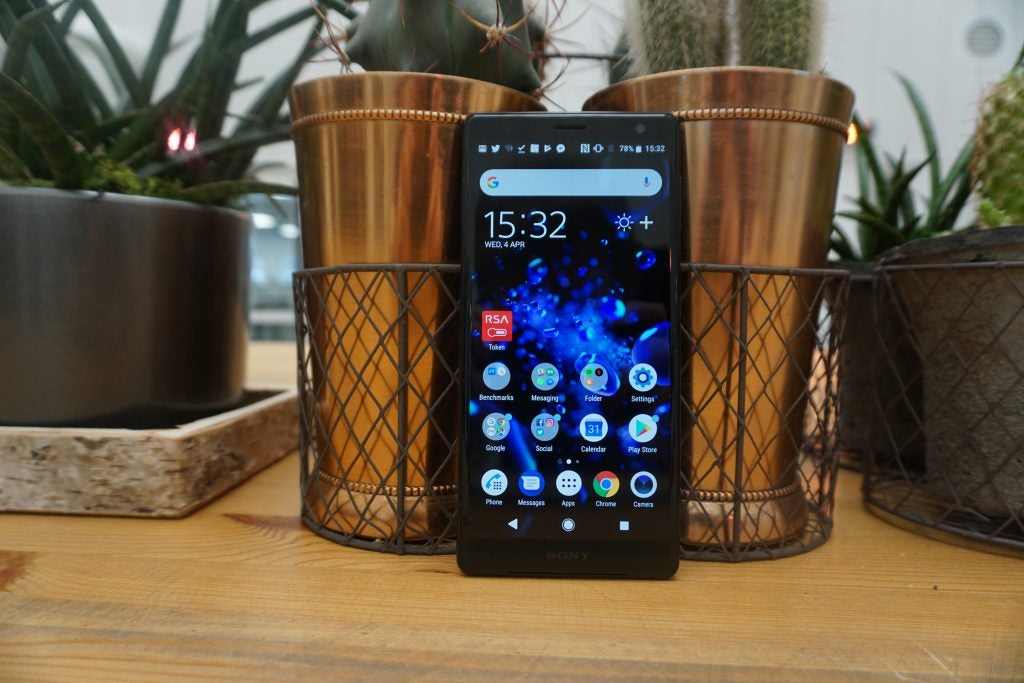 Sony Xperia XZ2 smartphone on wooden table with plants