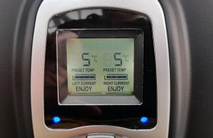 Digital display of wine cooler showing preset and current temperatures