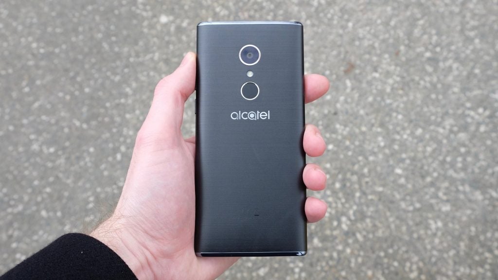 Hand holding Alcatel 5 smartphone showing rear camera and logo.