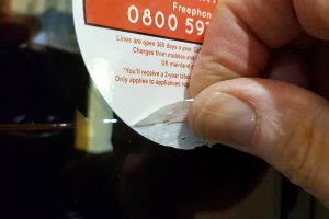Peeling label on a Baumatic wine cooler warranty card.