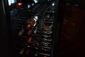 Baumatic wine cooler interior with bottles on racks.