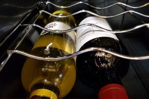 Close-up of wine bottles inside Baumatic wine cooler racks.