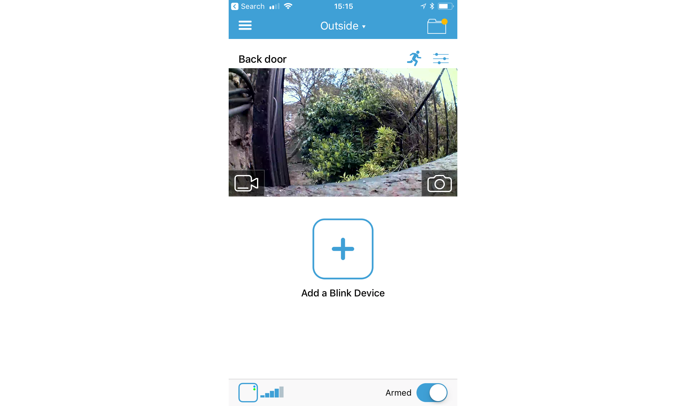 Blink XT camera interface with a view of a backyard.