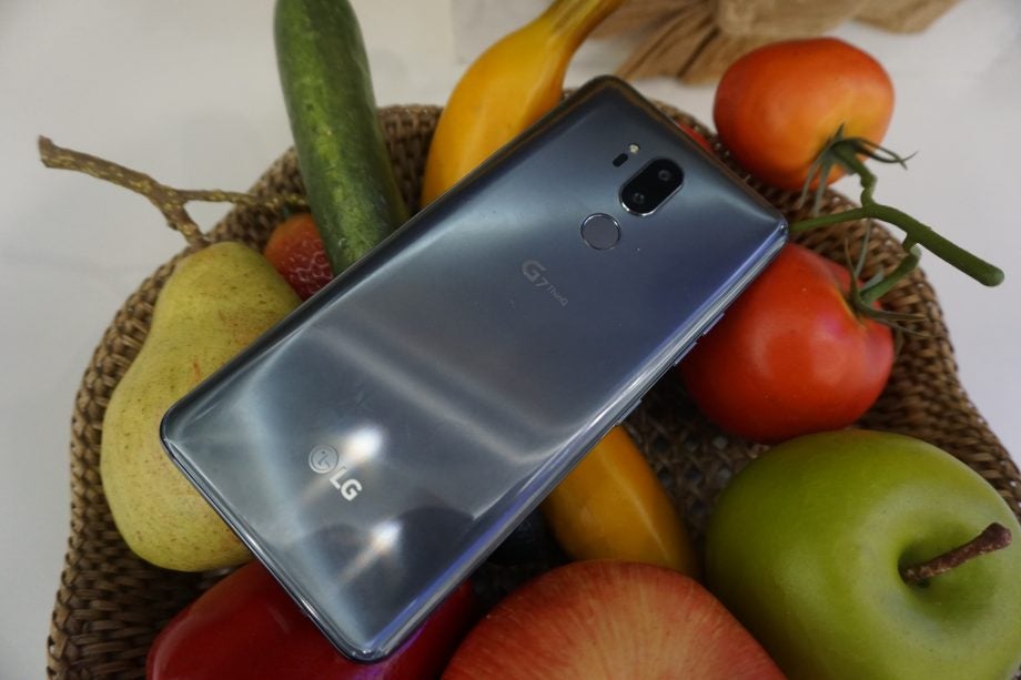 LG G7 ThinQ smartphone with dual cameras on fruit basket.