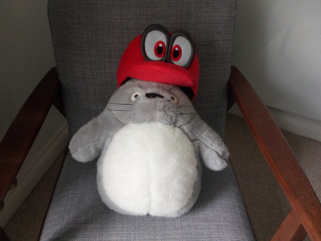 Plush toy resembling a video game character sitting on a chair.