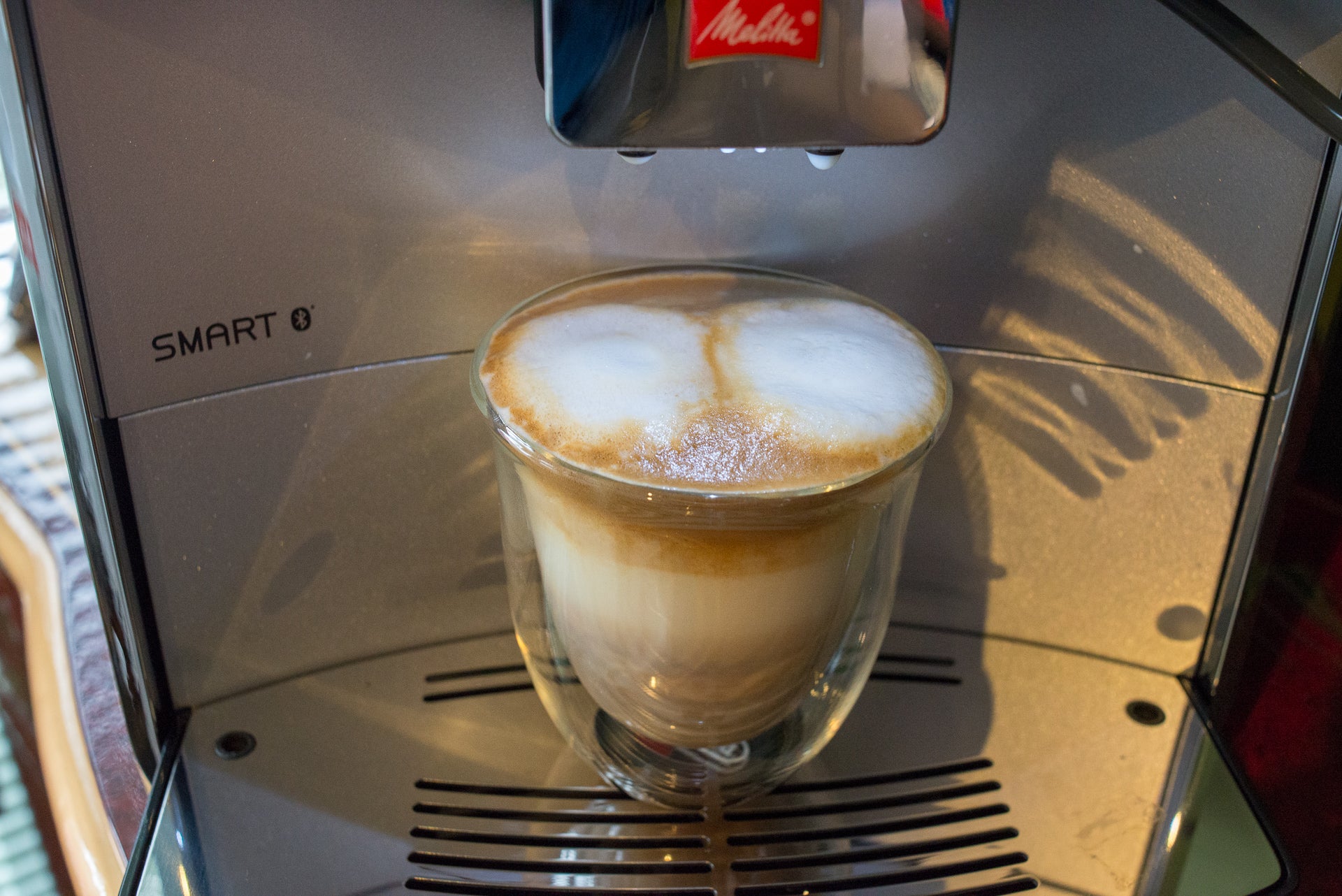 Melitta Caffeo Barista TS Smart with freshly brewed cappuccino.