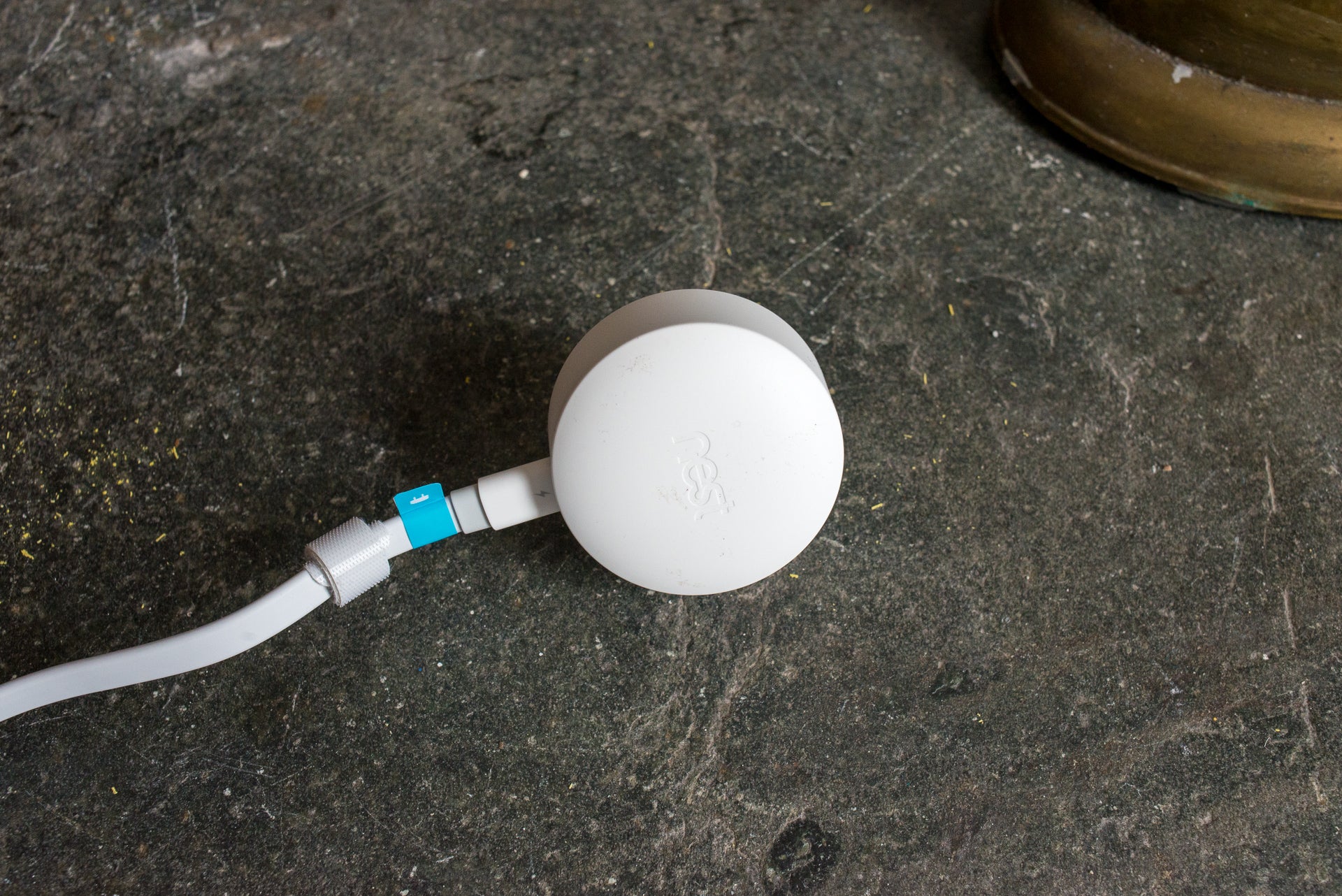Nest Cam IQ Outdoor power adapter on floor.