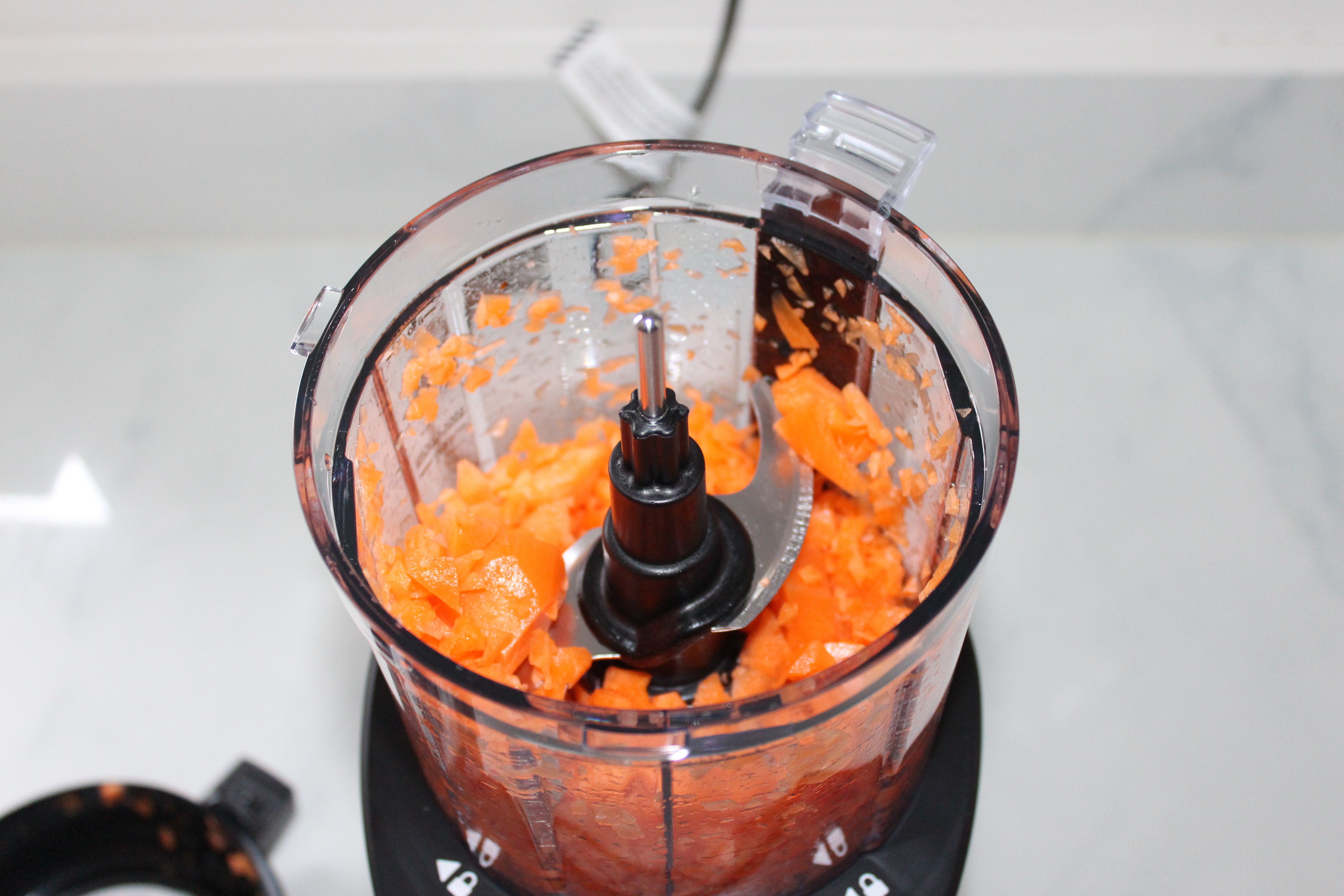 Ninja food processor with chopped carrots inside.
